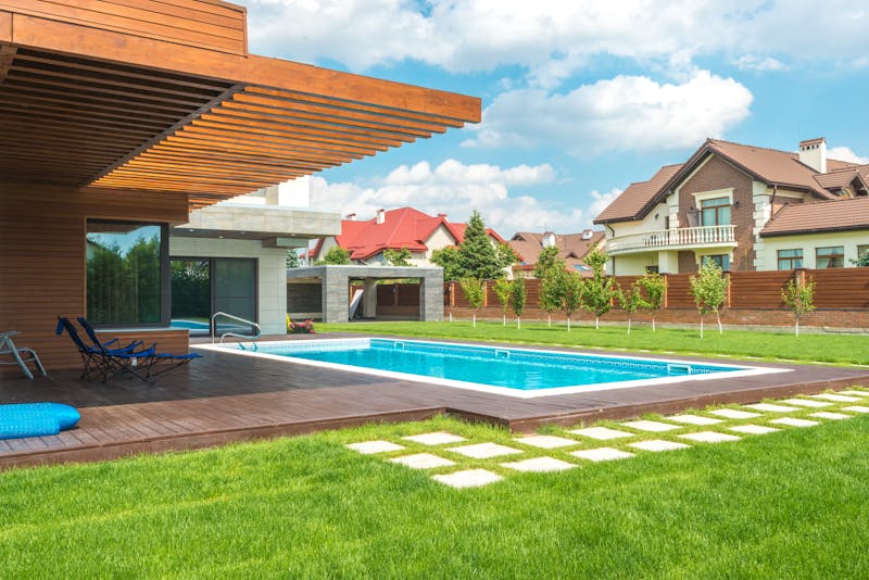 a backyard deck with a pool